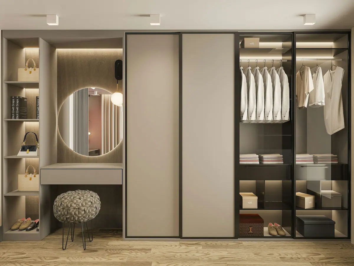 Closet com espelho redondo iluminado, cabideiros e banqueta